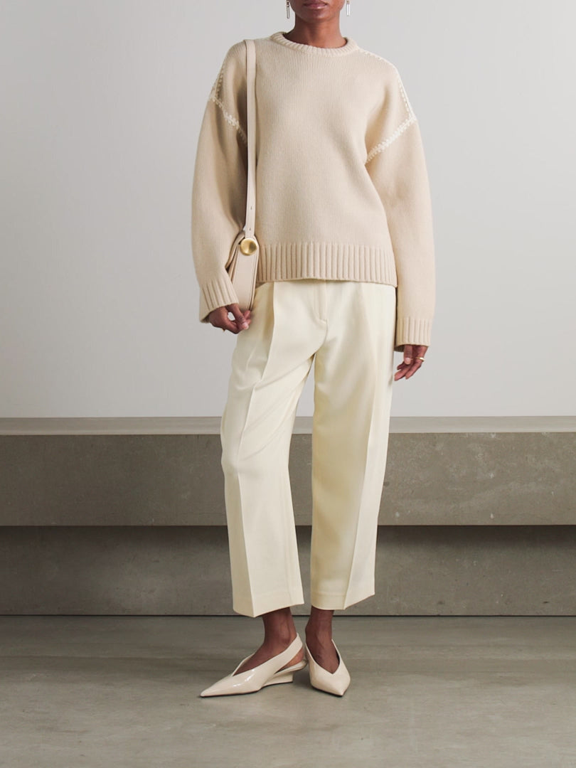 Elevate your wardrobe with this oversized sweater by Toteme crafted from a sumptuous wool and cashmere blend. Its relaxed fit with dropped shoulders offers effortless comfort, while the contrasting cream embroidery adds a refined, distinctive touch. Designed as a timeless staple, it seamlessly enriches your collection, providing both warmth and style for any occasion.