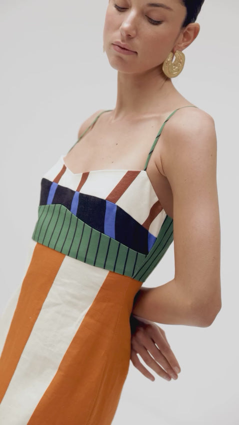 A celebration of color and pattern, the Paloma Dress features a striking mix of stripes and color blocks in bold hues across the bodice, while vertical stripes adorn the skirt. Thin straps and a sweetheart neckline create an effortlessly elegant silhouette that's sure to turn heads. Perfect for making a statement with vibrant style.