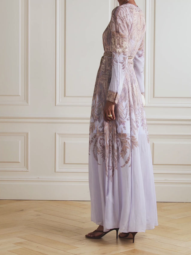 Twirl into elegance with this stunning belted printed chiffon maxi dress. Crafted from luxuriously semi-sheer fabric, it showcases an ornate tapestry-like print bursting with paisley and botanical details that'll have everyone asking where you found it. The removable scarf-style belt lets you cinch and style as you please, while the included slip ensures you've got the coverage you need without sacrificing that dreamy, floaty vibe. Perfect for making a graceful entrance at any occasion.
