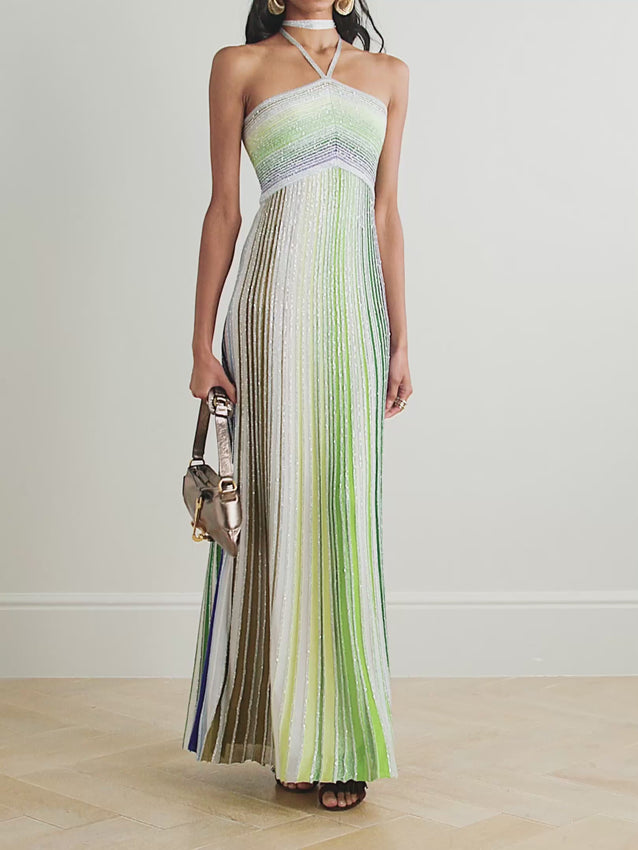 Missoni’s Sequin-embellished Metallic Crochet-knit Halterneck Maxi Dress elevates occasion dressing with vibrant style. Crafted in Italy with metallic threads, its vivid striped pattern catches the eye, while shimmering sequins add an elegant sparkle. The silver halterneck strap beautifully frames the collarbones, making this dress a stunning choice for any special event.