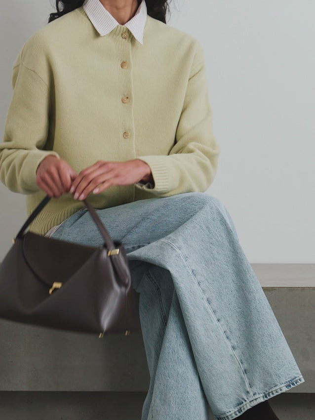Meet the T-Lock leather shoulder bag—named for its signature polished fastening that anchors this understated design. Handcrafted in Italy with buttery-soft leather, this bag curves gracefully against your body while precision topstitching reinforces every seam. Four protective feet keep the base pristine, and the removable shoulder strap offers versatile carry options. The suede-lined interior fits a continental wallet, sunglasses, and cosmetics with room to spare.