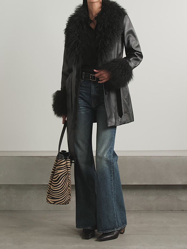 The Sefa jacket exemplifies understated luxury through its refined construction. Crafted from supple leather, it features a sumptuous shearling collar and cuffs that add warmth and texture without compromising the clean silhouette. An included belt allows you to define your waist and customize the fit to your preference. This is a versatile piece that transitions effortlessly from casual to polished occasions, delivering timeless style with every wear.