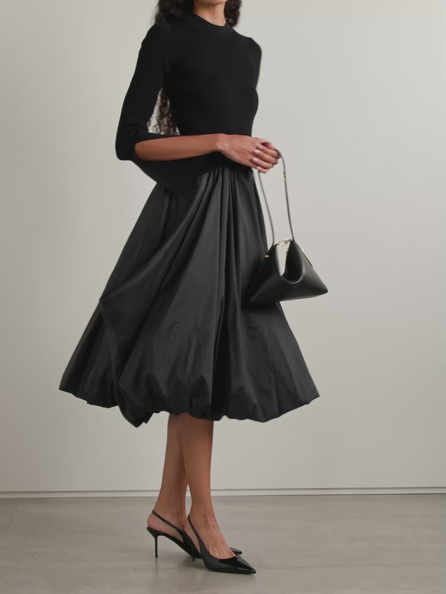 The Kenlie Ribbed-Knit and Taffeta Midi Dress by Simkhai combines a sleek, fitted bodice with a voluminous taffeta skirt that maintains its fullness thanks to soft pleats and a charming bubble hem. This elegant design offers a flattering silhouette that stays graceful whether you’re standing or sitting. Perfect for special occasions, pair it with pumps and understated jewelry to complete a sophisticated and captivating look.