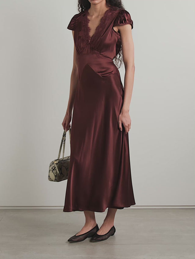 The Coraline maxi dress channels romantic lingerie-inspired elegance with delicate lace trims framing the V-neckline. Crafted from lustrous silk-satin panels, the dress features strategic cuts and placement that guide the eye inward, creating a flattering silhouette. Gently puffed sleeves add softness, while adjustable slim ties at the waist let you customize the fit and accentuate your curves. Perfect for evening occasions or special moments when you want to feel effortlessly sophisticated.