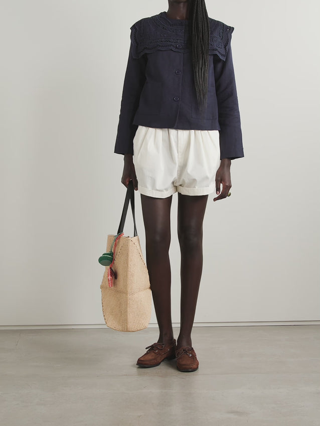 Introducing the Marie jacket—Sea's charming take on effortless style. This boxy beauty features a delicate broderie anglaise panel spelling out the brand name across the back, adding a whimsical touch to your everyday wardrobe. Crafted from a breathable cotton and linen blend, it's the perfect weight for layering through seasons. Practical front pockets keep your essentials close while you move through your day. Whether you're dressing up a simple tee or throwing it over a sundress, Marie brings personality