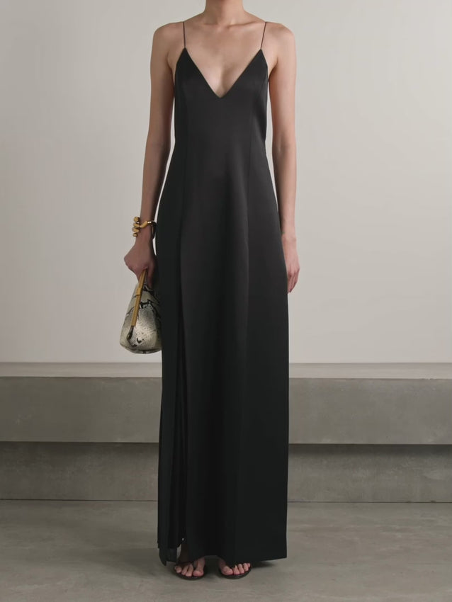 Slip into Khaite's 'Nonya' dress and let the drama unfold. Crafted from luxe black crepe, this column silhouette flows with effortless elegance, anchored by delicate pin-thin straps framing a daring plunge neckline. Strategic side splits inject movement and reveal a tantalizing glimpse of leg as you stride. Channel the Spring '24 runway energy by pairing it with statement gold jewelry—think our 'Hand' cuffs for the perfect finishing touch. Understated yet undeniably bold.
