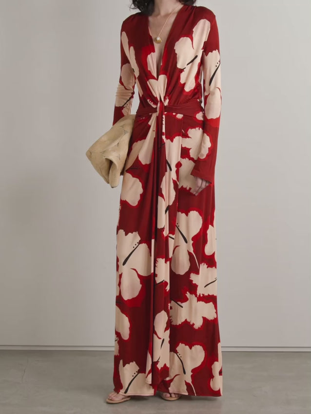 This Coral Marino Draped Printed Stretch-jersey Maxi Dress by Johanna Ortiz showcases vibrant hibiscus flowers inspired by the designer’s Colombian roots. Crafted from smooth stretch-jersey, it features a narrow V-neckline that elegantly frames the décolletage and a draped, nipped-in waist that enhances the silhouette with refined sophistication. Perfect for making a graceful statement at any event.