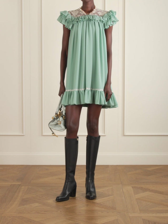 Chloé's Spring '26 collection celebrates the interplay between imagination and reality, brought to life through romantic, ethereal silhouettes. This silk-georgette mini dress draws inspiration from vintage nightwear and babydoll styles, showcasing intricate lace accents and feminine ruffles positioned off the shoulders. A captivating piece that seamlessly merges dreamlike aesthetics with refined, wearable elegance.