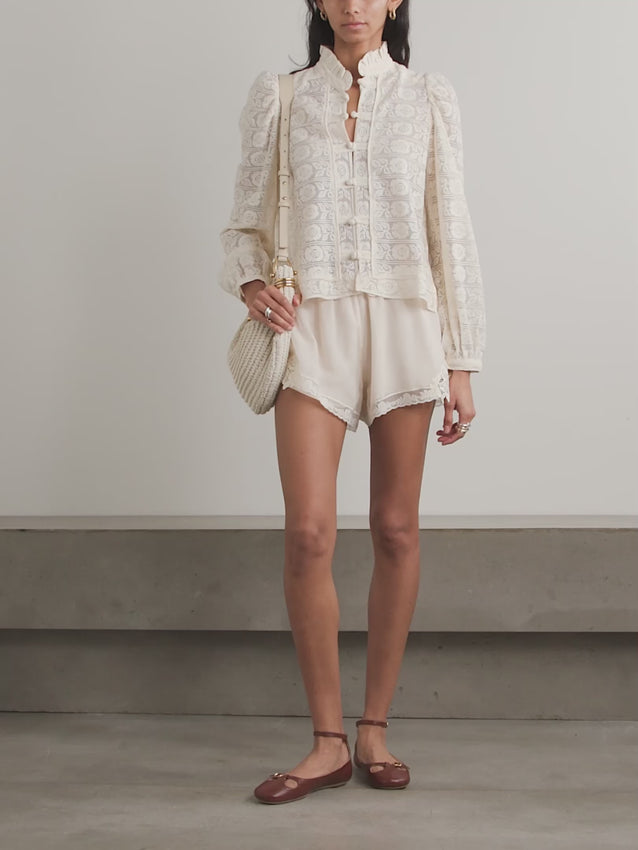 Alix of Bohemia was born from a founder's passion for vintage fabrics, bringing retro charm to every piece. The Artemis blouse showcases delicate cotton-lace with voluminous sleeves that capture effortless bohemian elegance. A ruffled neckline adds romantic detail and movement, making this shirt perfect for those who embrace vintage-inspired style with modern comfort.