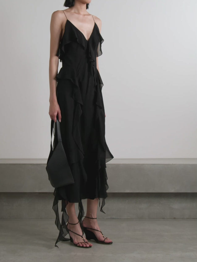 Twirl into the spotlight in Khaite's Pim dress, where cascading ruffles dance with every step. Crafted from airy silk-georgette and designed in Italy, this midi beauty floats effortlessly from delicate straps. Whether you're gliding across a ballroom or stealing the show at your next event, those flouncy layers promise to turn heads and make a statement.