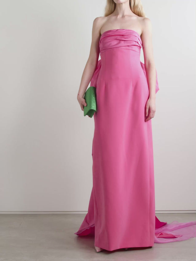 Step into the spotlight in this show-stopping strapless gown by Carolina Herrera that screams timeless elegance. Crafted from luxurious silk-organza trimmed taffeta, the draped bodice hugs your curves in all the right ways while the dramatic bow adorning the back adds that unforgettable wow factor. A graceful silk faille train trails behind you as you move, ensuring every entrance feels like a red carpet moment. Perfect for galas, weddings, and those nights when you want to feel absolutely stunning.