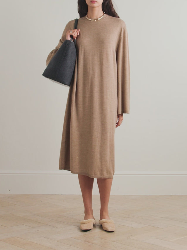 Elevate your everyday with this wool midi dress that proves comfort doesn't have to compromise on style. Crafted from sumptuous soft wool, it features a relaxed silhouette with dropped shoulders and cozy ribbed trims—the perfect excuse to skip traditional loungewear. Pair it with your favorite boots for an effortlessly chic look, or go full comfort mode with shearling slippers for those days when you're staying in but still want to feel fabulous.