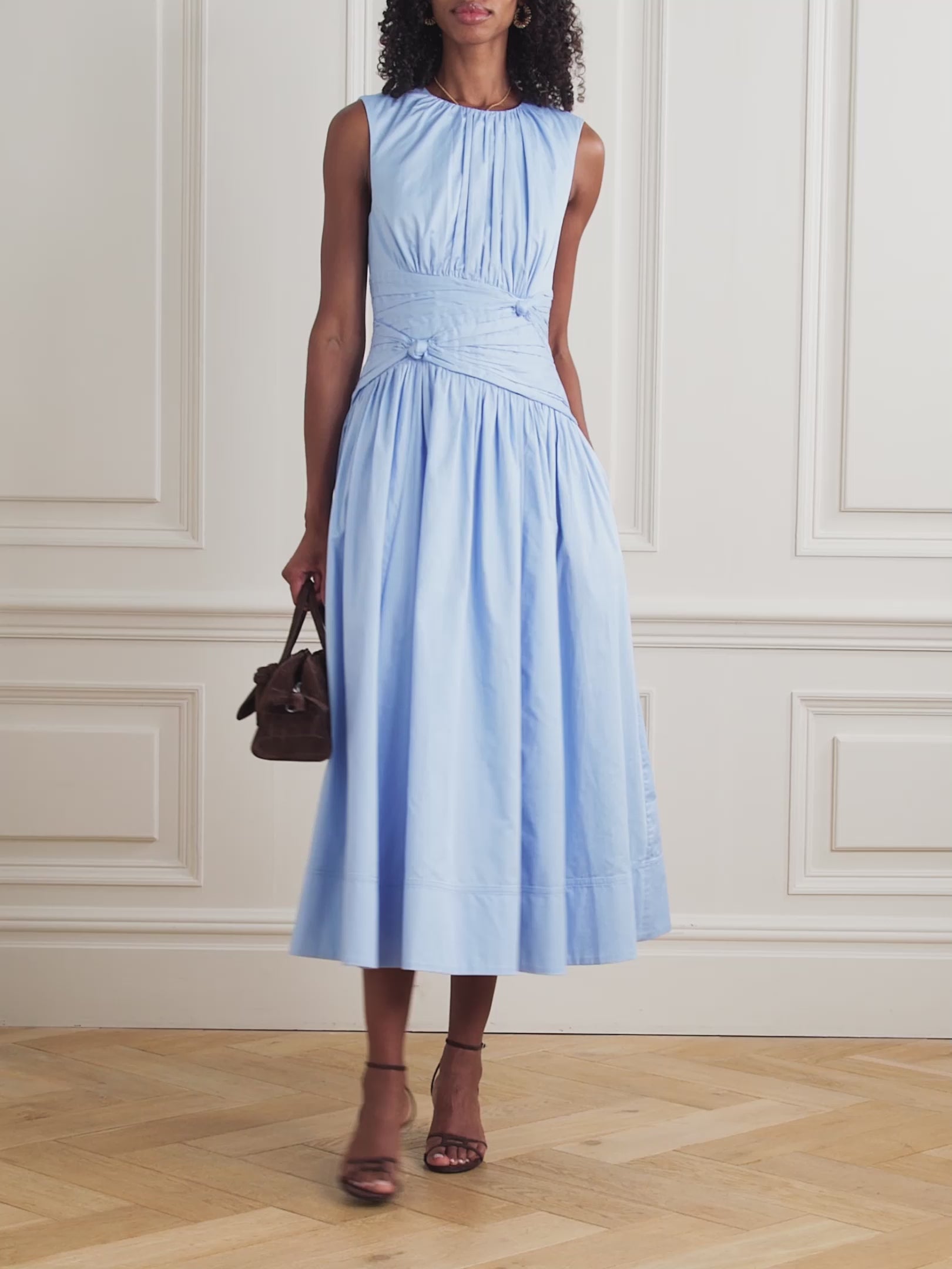 The Agatha Poplin Midi Dress by Aje features a flattering gathered, knotted waist that accentuates your silhouette. Crafted from soft cotton-poplin, it offers gentle pleats that add volume and flow elegantly to a midi length. In a versatile Powder Blue shade, this dress pairs beautifully with gold, silver, or pearl accessories, making it a perfect choice for both casual and refined occasions.