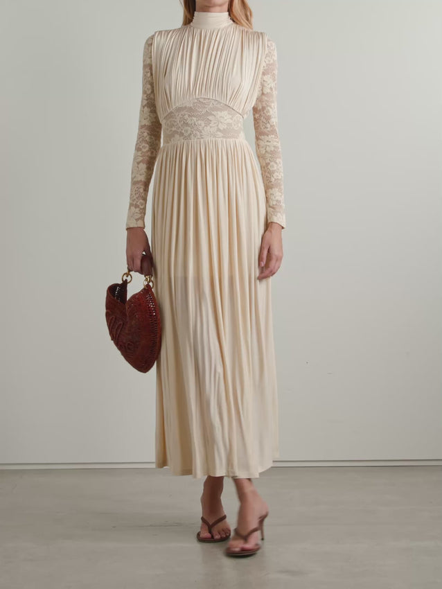 Ethereal and effortless, this Rebellion maxi dress captures understated elegance through thoughtful design. Crafted from gathered stretch-jersey, the fabric drapes beautifully while maintaining a comfortable fit. A curved lace waistband adds delicate detail and definition, while matching lace sleeves soften the silhouette. The relaxed ruching creates movement and dimension with every step. Perfect for garden parties, evening events, or romantic occasions. 