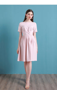 Upgrade your summer wardrobe with the elegant and sophisticated Robe Dahlia. This dress features a high-end Hepburn style, one-line collar, and a medium length pleated skirt for a flattering fit. Perfect for any occasion, this dress exudes timeless femininity in a soft pink color. Stay stylish and comfortable in this must-have dress.