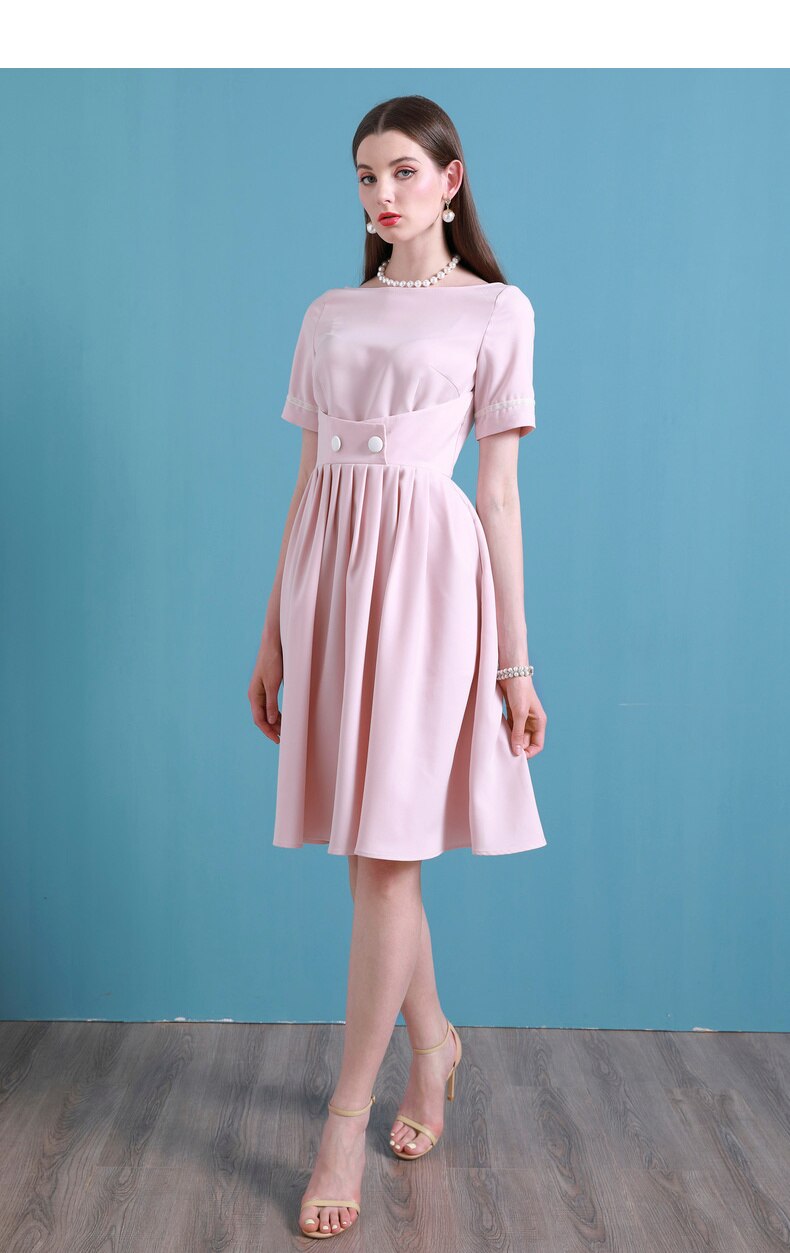 Upgrade your summer wardrobe with the elegant and sophisticated Robe Dahlia. This dress features a high-end Hepburn style, one-line collar, and a medium length pleated skirt for a flattering fit. Perfect for any occasion, this dress exudes timeless femininity in a soft pink color. Stay stylish and comfortable in this must-have dress.