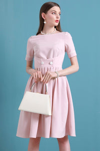 Upgrade your summer wardrobe with the elegant and sophisticated Robe Dahlia. This dress features a high-end Hepburn style, one-line collar, and a medium length pleated skirt for a flattering fit. Perfect for any occasion, this dress exudes timeless femininity in a soft pink color. Stay stylish and comfortable in this must-have dress.