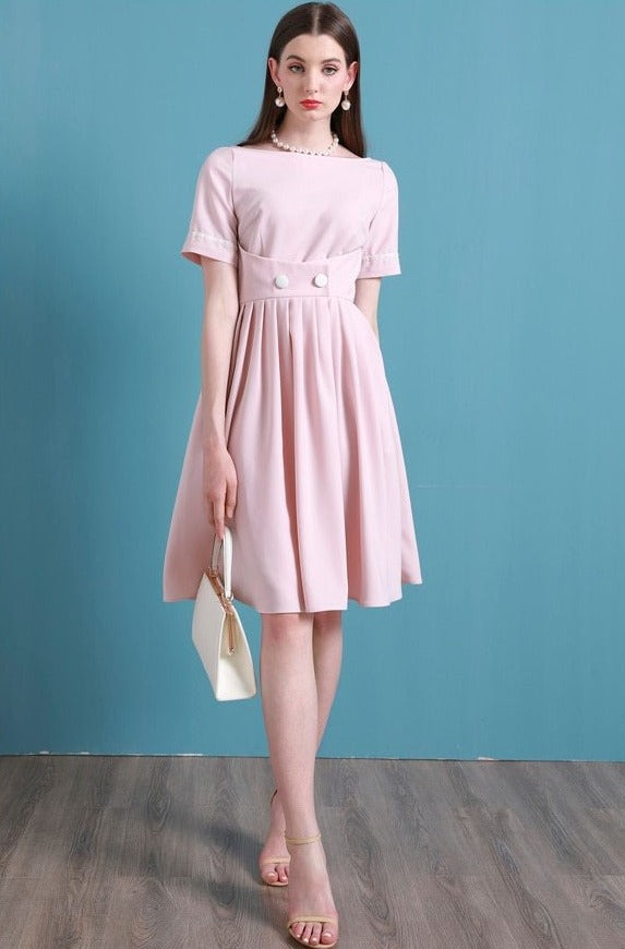 Upgrade your summer wardrobe with the elegant and sophisticated Robe Dahlia. This dress features a high-end Hepburn style, one-line collar, and a medium length pleated skirt for a flattering fit. Perfect for any occasion, this dress exudes timeless femininity in a soft pink color. Stay stylish and comfortable in this must-have dress.