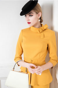 The Ensemble Madoline is a luxurious statement piece for elite women in the workplace. Crafted with the finest warm and amazing mango yellow fabric, the ensemble offers a simple half high collar and waist design with a bow element to embellish the swan neck. 