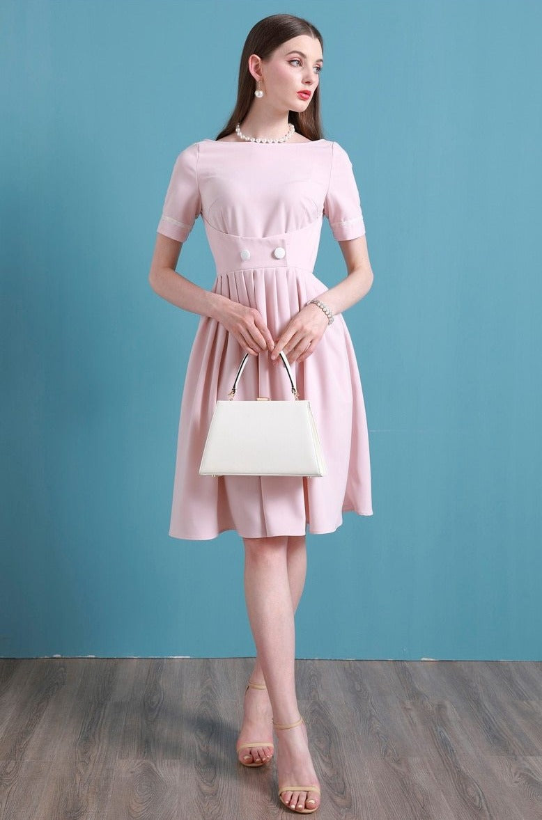 Upgrade your summer wardrobe with the elegant and sophisticated Robe Dahlia. This dress features a high-end Hepburn style, one-line collar, and a medium length pleated skirt for a flattering fit. Perfect for any occasion, this dress exudes timeless femininity in a soft pink color. Stay stylish and comfortable in this must-have dress.