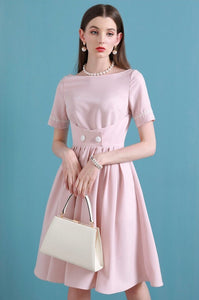 Upgrade your summer wardrobe with the elegant and sophisticated Robe Dahlia. This dress features a high-end Hepburn style, one-line collar, and a medium length pleated skirt for a flattering fit. Perfect for any occasion, this dress exudes timeless femininity in a soft pink color. Stay stylish and comfortable in this must-have dress.