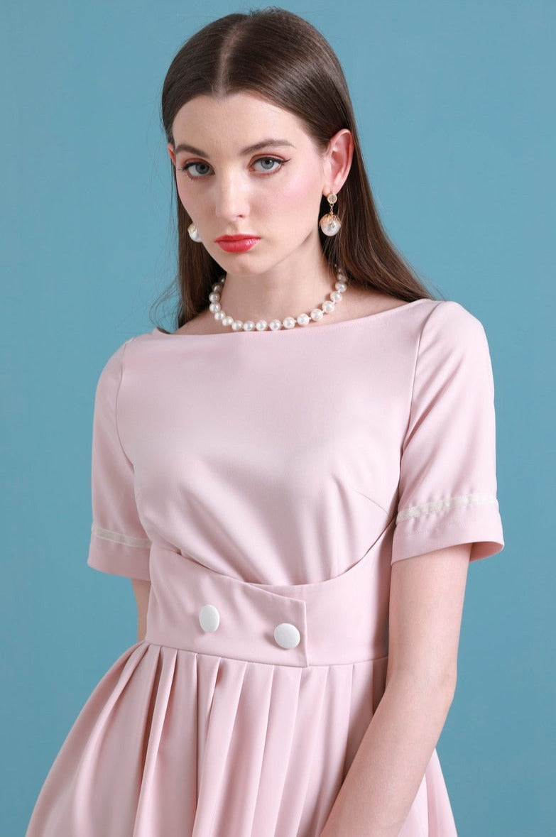 Upgrade your summer wardrobe with the elegant and sophisticated Robe Dahlia. This dress features a high-end Hepburn style, one-line collar, and a medium length pleated skirt for a flattering fit. Perfect for any occasion, this dress exudes timeless femininity in a soft pink color. Stay stylish and comfortable in this must-have dress.