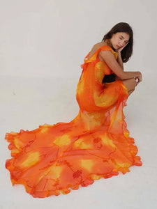 This stunning Dress Sunset features a vibrant orange tie-dyed print, perfect for those sunny summer days. The low cut back and backless design add a touch of allure, while the ruffle and high split details give it a chic and feminine look. Elevate your style and turn heads at any party or evening event with this eye-catching dress.