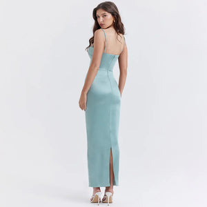 Indulge in luxury with our 'Constanza' dress, made from exquisite shimmering satin in a stunning light jade color. The corset-style bodice contours your curves while the delicate scalloped trim and barely-visible straps add a touch of elegance. The flowing maxi skirt with a slit allows for graceful movement and is fully lined for a smooth finish. 