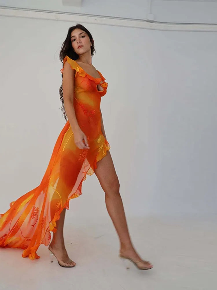 This stunning Dress Sunset features a vibrant orange tie-dyed print, perfect for those sunny summer days. The low cut back and backless design add a touch of allure, while the ruffle and high split details give it a chic and feminine look. Elevate your style and turn heads at any party or evening event with this eye-catching dress.