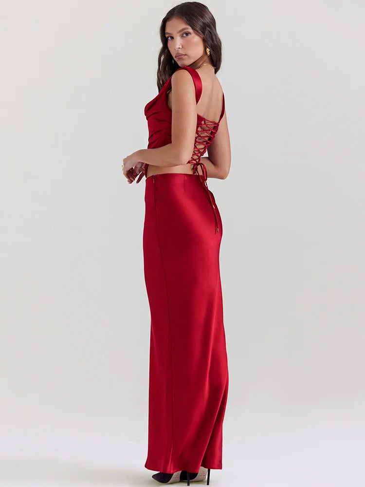 The Ensemble Pauline is perfect for any special occasion. Make a stunning entrance in this sleek two-piece set with a backless crop top and a long, elegant skirt. The sleeveless design and soft, luxurious fabric will keep you comfortable all night long. Shine on the dance floor and show off your best moves in this sexy skirt set.