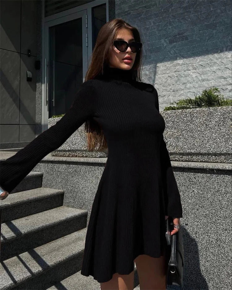 Upgrade your wardrobe with our Robe Kristina! This elegant knitted A-line mini sweater dress boasts a sexy turtleneck and flared sleeves. Perfect for any occasion, this dress will have you feeling confident and stylish. Stay warm and chic this season with our Robe Kristina.