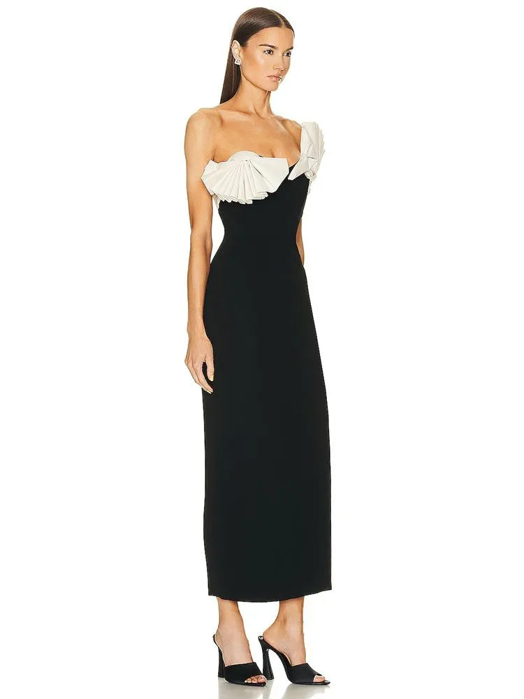 Unleash your inner confidence with the Lavina ruffled dress. Made with a strapless design and bandage material, this midi dress is both elegant and sexy. The black and white color scheme adds a touch of sophistication to any occasion. Feel comfortable, yet stylish with this dress that will hug your curves in all the right places.