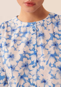 Introducing Blouse Cristine by Tara Jarmon. Designed with a relaxed silhouette and crafted from crisp cotton, this blouse exudes the brand's mod flair and feminine sensibility. Featuring a sweet blue floral motif and tie cuffs for a cinched bracelet length balloon sleeve, it's the perfect addition to your spring weekend wardrobe. Pair with lightweight pants or relaxed denim for a chic and sophisticated look.