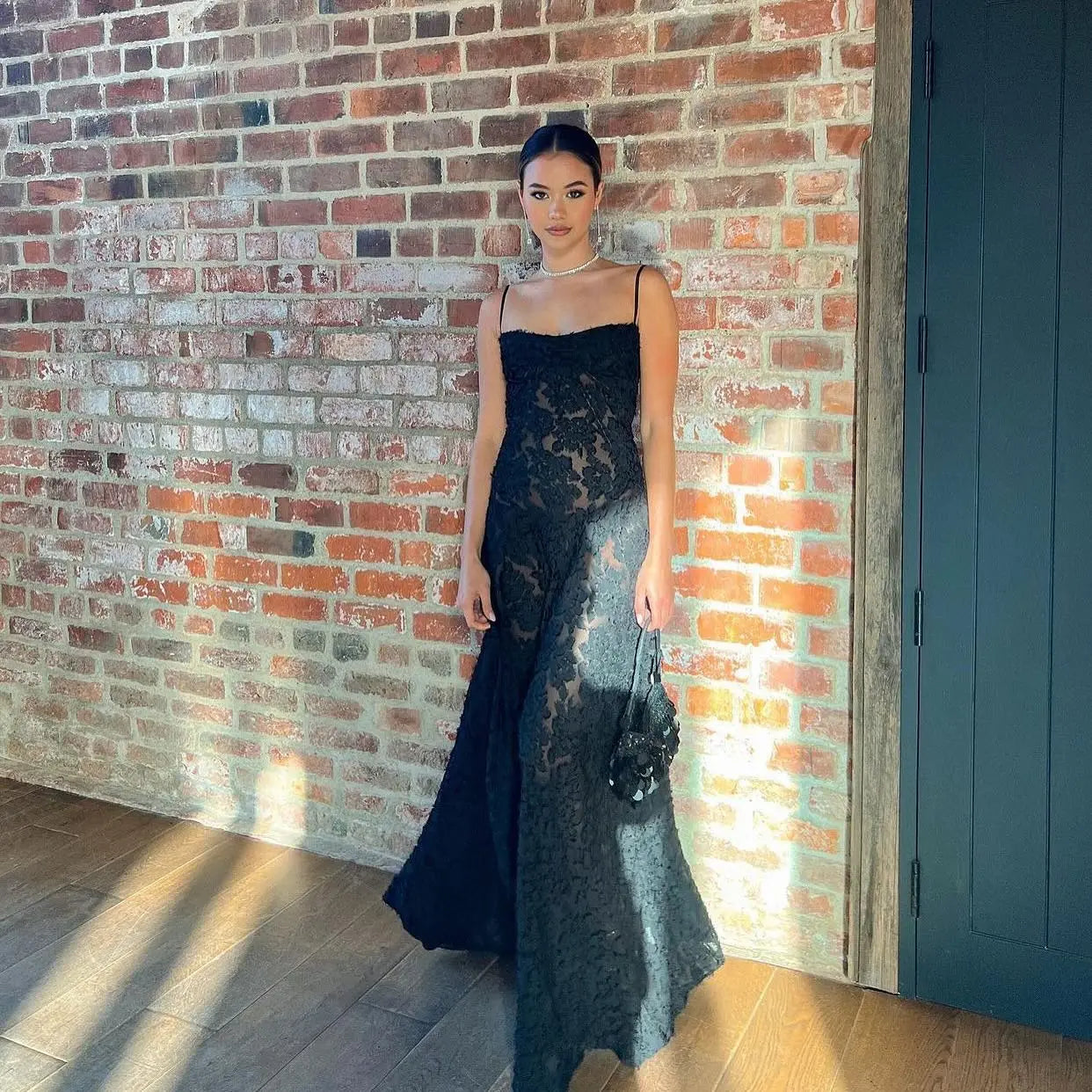 The Dress Seren is a stunning addition to any formal occasion. With its elegant and beautiful black appliques, this maxi dress is sure to turn heads. Perfect for dancing parties, its long silhouette exudes sophistication and luxury. Elevate your wardrobe with this must-have dress.