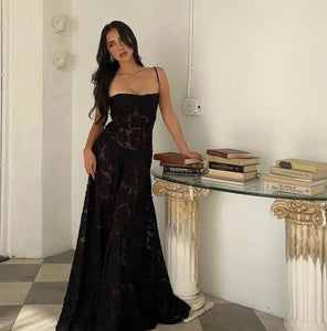 The Dress Seren is a stunning addition to any formal occasion. With its elegant and beautiful black appliques, this maxi dress is sure to turn heads. Perfect for dancing parties, its long silhouette exudes sophistication and luxury. Elevate your wardrobe with this must-have dress.