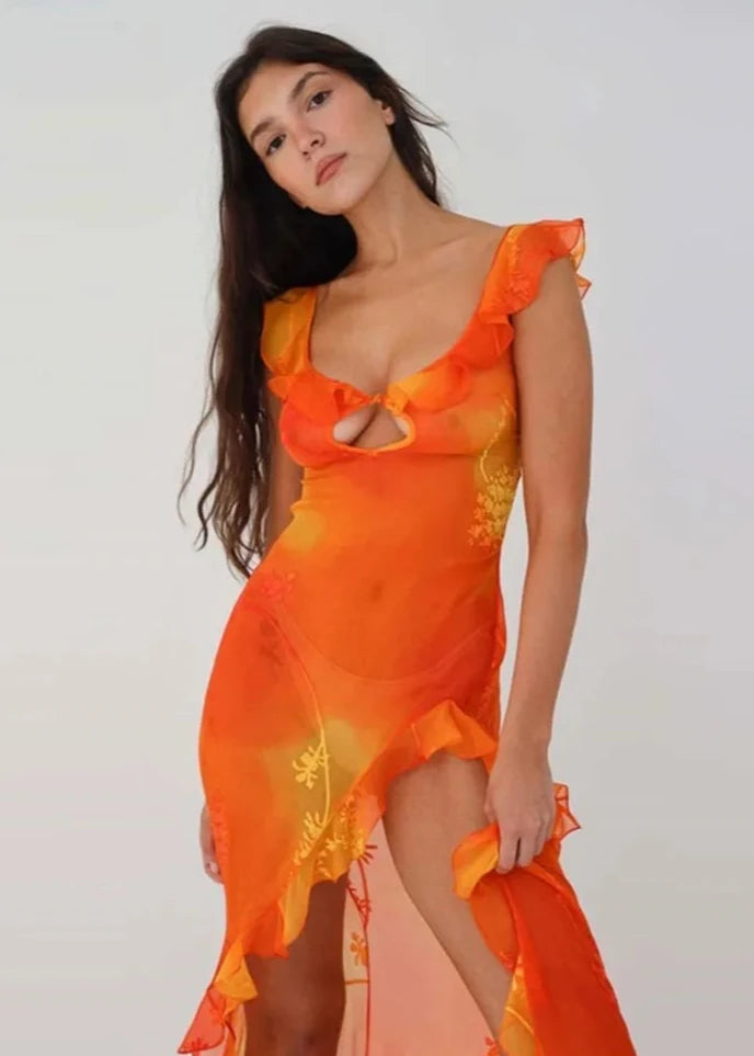 This stunning Dress Sunset features a vibrant orange tie-dyed print, perfect for those sunny summer days. The low cut back and backless design add a touch of allure, while the ruffle and high split details give it a chic and feminine look. Elevate your style and turn heads at any party or evening event with this eye-catching dress.