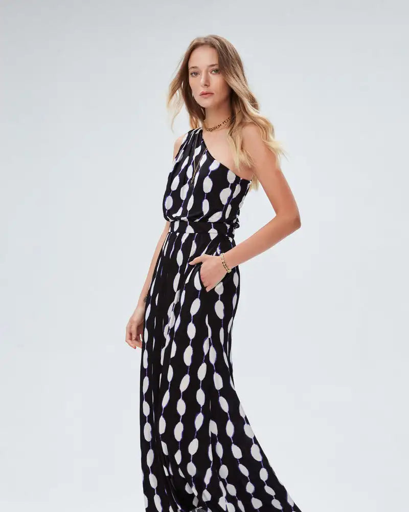 Elevate your style with our French Style Fashion Dress by DVF. This one-shoulder, mid-length dress features a unique abstract print, adding a personalized touch to your wardrobe. Stand out from the crowd and make a statement with this original and stylish dress.