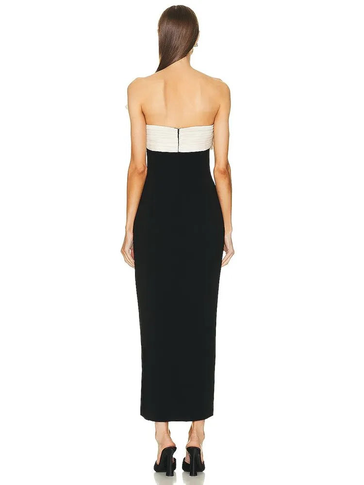 Unleash your inner confidence with the Lavina ruffled dress. Made with a strapless design and bandage material, this midi dress is both elegant and sexy. The black and white color scheme adds a touch of sophistication to any occasion. Feel comfortable, yet stylish with this dress that will hug your curves in all the right places.