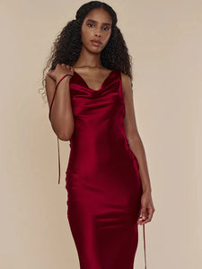 This satin backless bandage dress features spaghetti straps and a v-neck design, making it a sexy and stylish choice for any occasion. The maxi length adds an elegant touch, while the bandage material provides a flattering fit. Perfect for making a statement at any event.