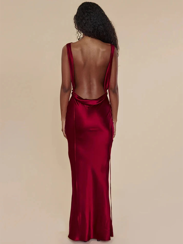 This satin backless bandage dress features spaghetti straps and a v-neck design, making it a sexy and stylish choice for any occasion. The maxi length adds an elegant touch, while the bandage material provides a flattering fit. Perfect for making a statement at any event.