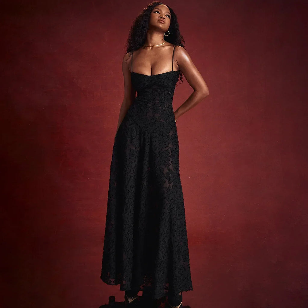 The Dress Seren is a stunning addition to any formal occasion. With its elegant and beautiful black appliques, this maxi dress is sure to turn heads. Perfect for dancing parties, its long silhouette exudes sophistication and luxury. Elevate your wardrobe with this must-have dress.