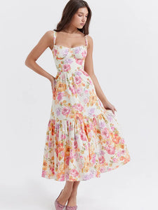 Introducing the Robe Dannica - a perfect summer dress for women. With its vibrant floral print, spaghetti straps, and pleated A-line silhouette, this dress is both stylish and sexy. The sleeveless and backless design adds an element of playfulness to its already flirty look. Get ready to turn heads in this printed midi dress!