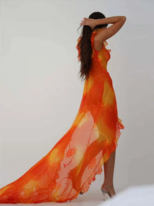 This stunning Dress Sunset features a vibrant orange tie-dyed print, perfect for those sunny summer days. The low cut back and backless design add a touch of allure, while the ruffle and high split details give it a chic and feminine look. Elevate your style and turn heads at any party or evening event with this eye-catching dress.