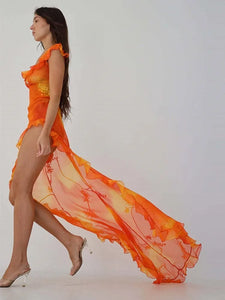 This stunning Dress Sunset features a vibrant orange tie-dyed print, perfect for those sunny summer days. The low cut back and backless design add a touch of allure, while the ruffle and high split details give it a chic and feminine look. Elevate your style and turn heads at any party or evening event with this eye-catching dress.