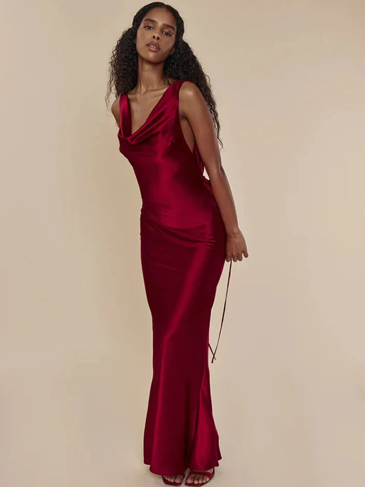 This satin backless bandage dress features spaghetti straps and a v-neck design, making it a sexy and stylish choice for any occasion. The maxi length adds an elegant touch, while the bandage material provides a flattering fit. Perfect for making a statement at any event.